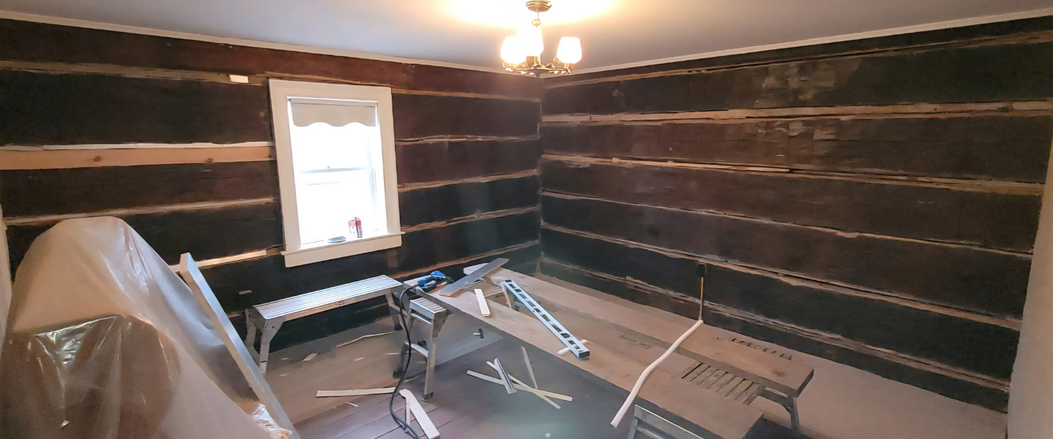 Technician using tools for log home maintenance in Lake Simcoe area