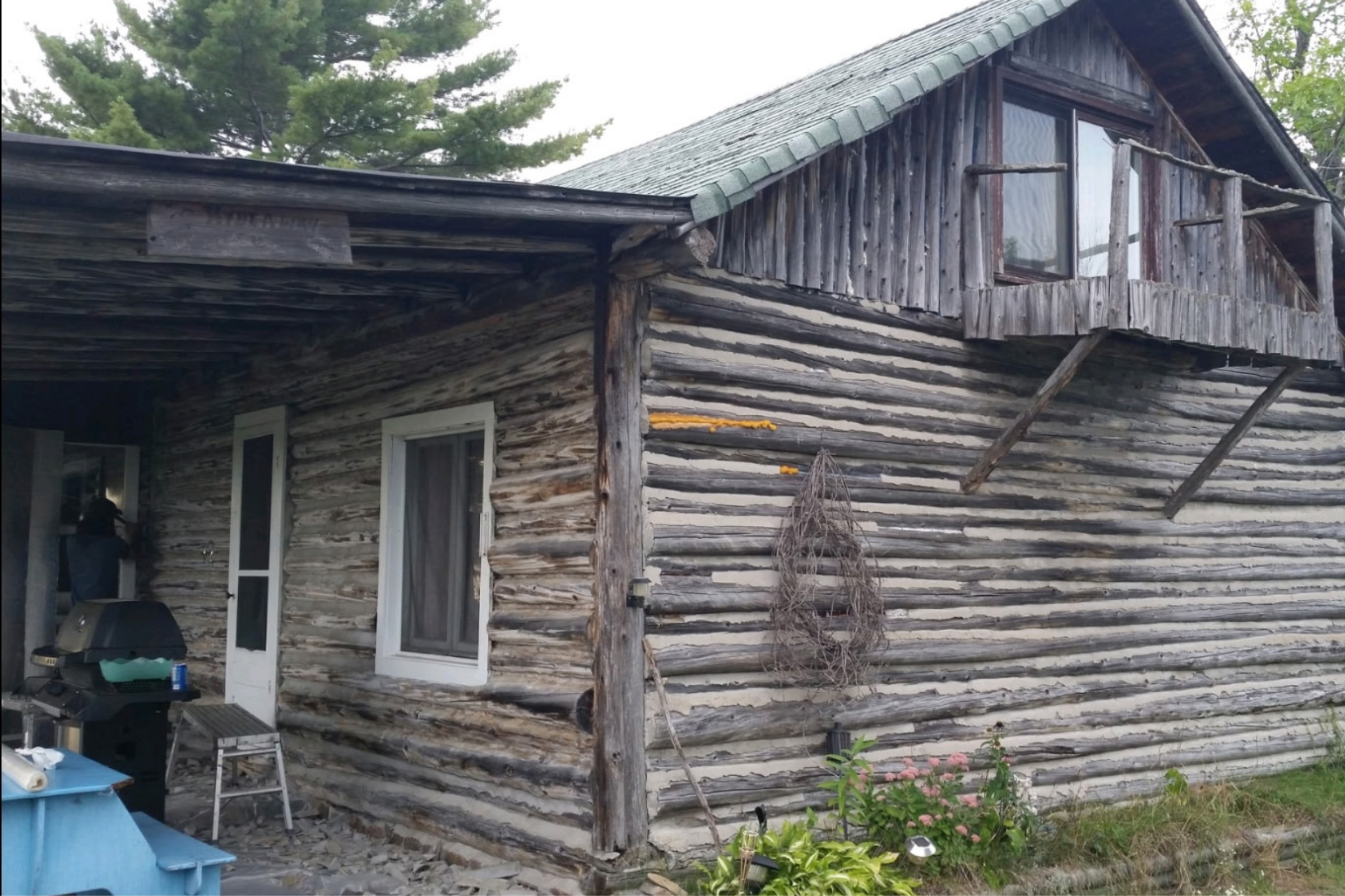 Ontario restoration team working on historic log cabin